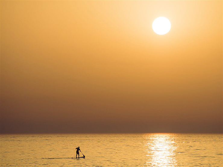 Beat the crowds with a a paddleboarding session first thing in the morning 