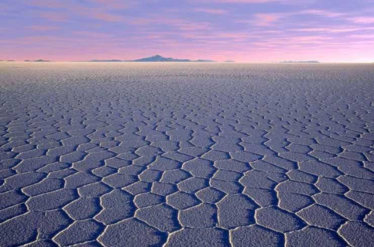 The Salar de Uyuni salt flats are an appetizing sight at sunrise. Image courtesy of Sergio Pessolano via Getty Images.