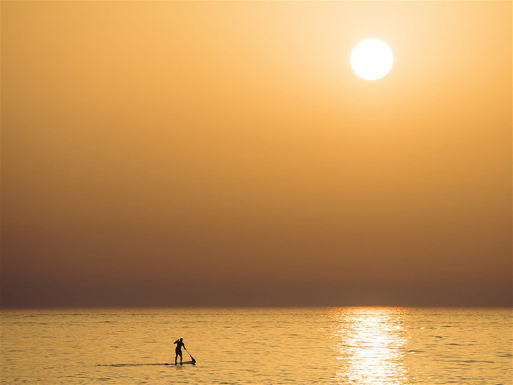 Beat the crowds with a a paddleboarding session first thing in the morning